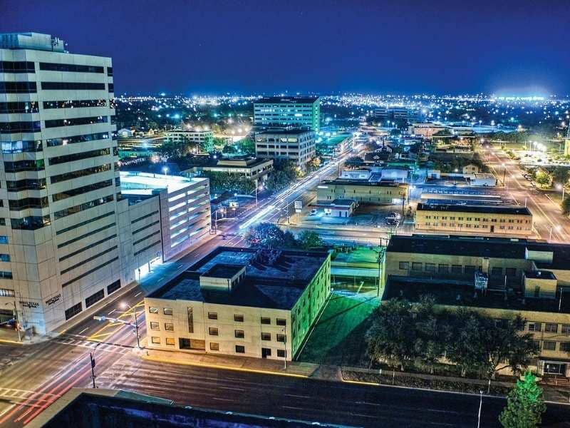 Downtown Midland, Texas night skyline with commercial buildings, road networks, and surrounding development areas relevant to land surveying and site planning